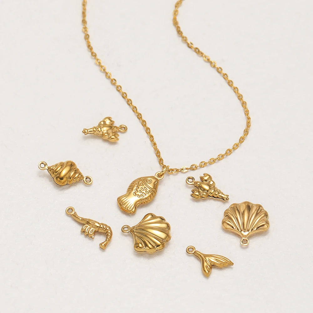 Gold hollow sea-life charm pendants with loops, including shells, starfish, fish
