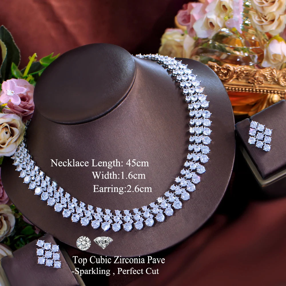 Silver-tone CZ cluster necklace with matching square earrings, on jewelry display