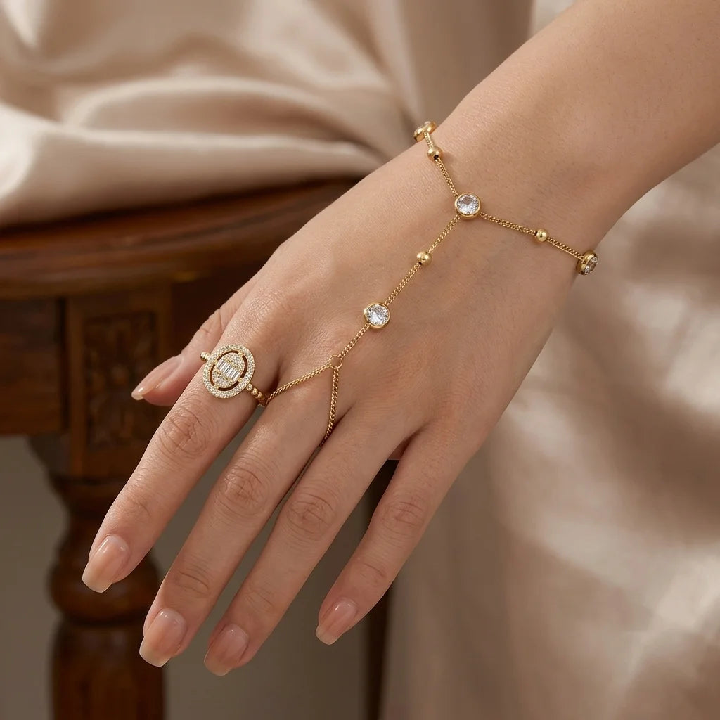 Gold-plated chain bracelet with round zircon beads and small ring on hand