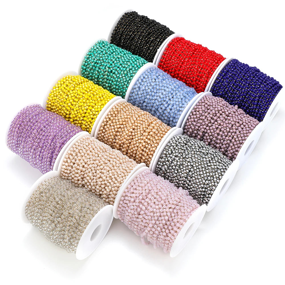 Faceted beaded chains spooled in assorted colors, including black, teal, red, and gold