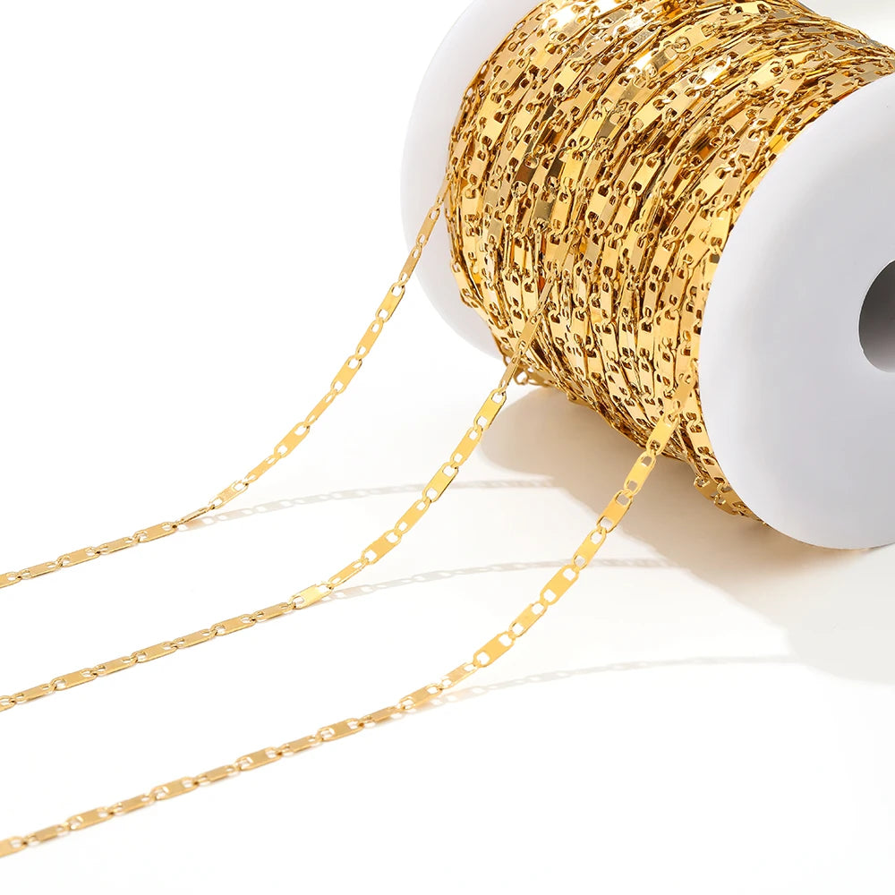 Gold flat link chain on a white spool with linked chain trailing