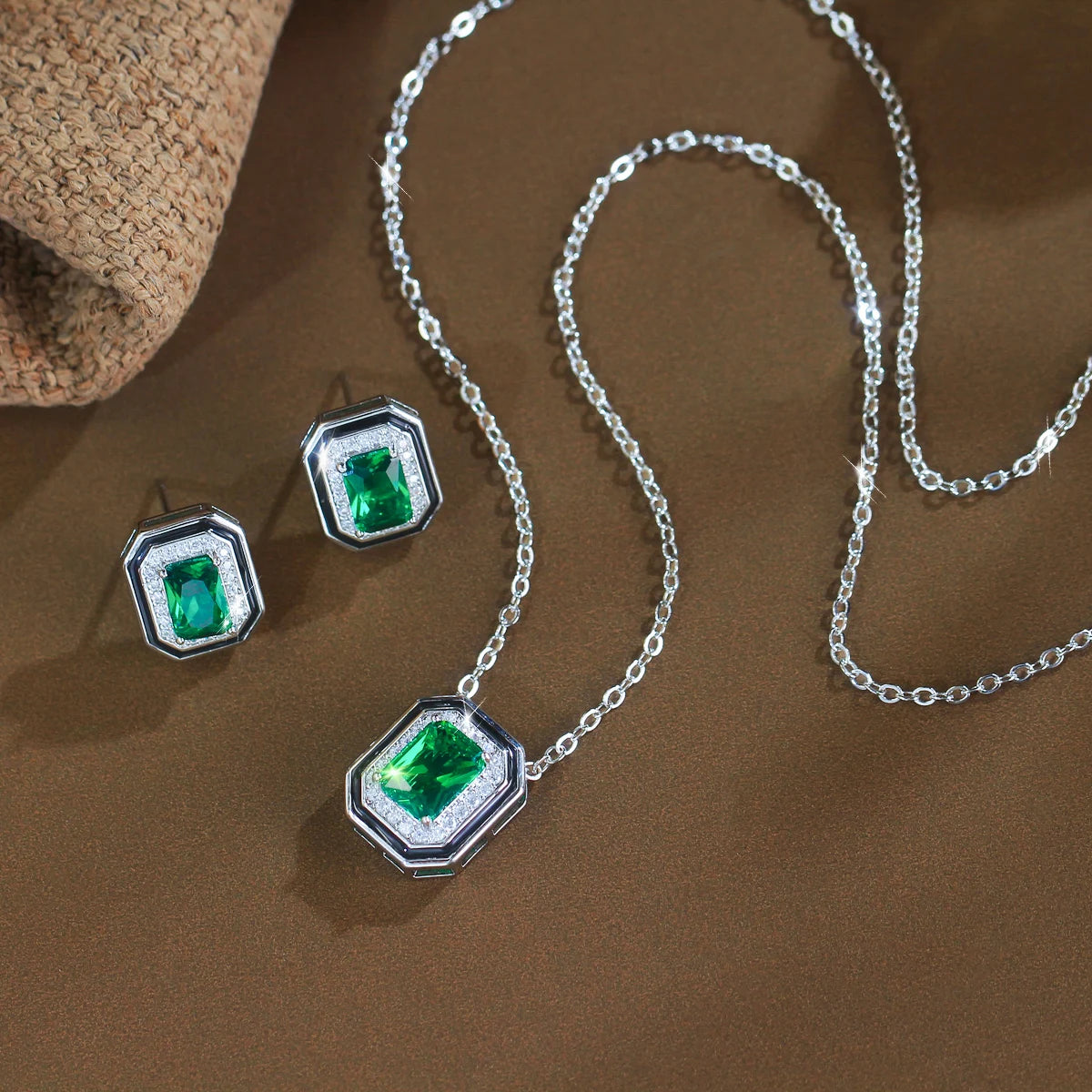 Green crystal jewelry set with a silver-tone pendant necklace and matching rectangular stud earrings