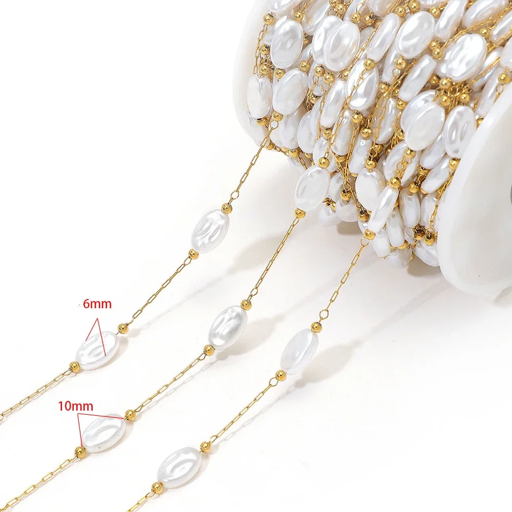 Artificial pearl chain with gold links and 6mm white oval beads