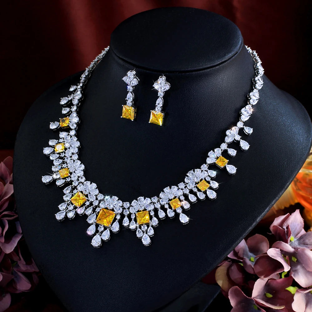 Cubic zirconia necklace and drop earrings set with yellow square accents, silver-tone.