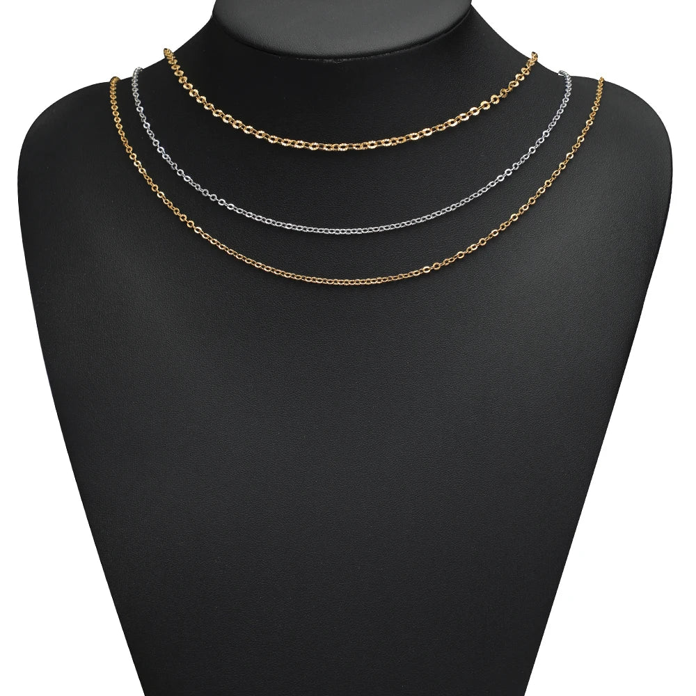 Layered chain necklace on a mannequin bust, gold and silver