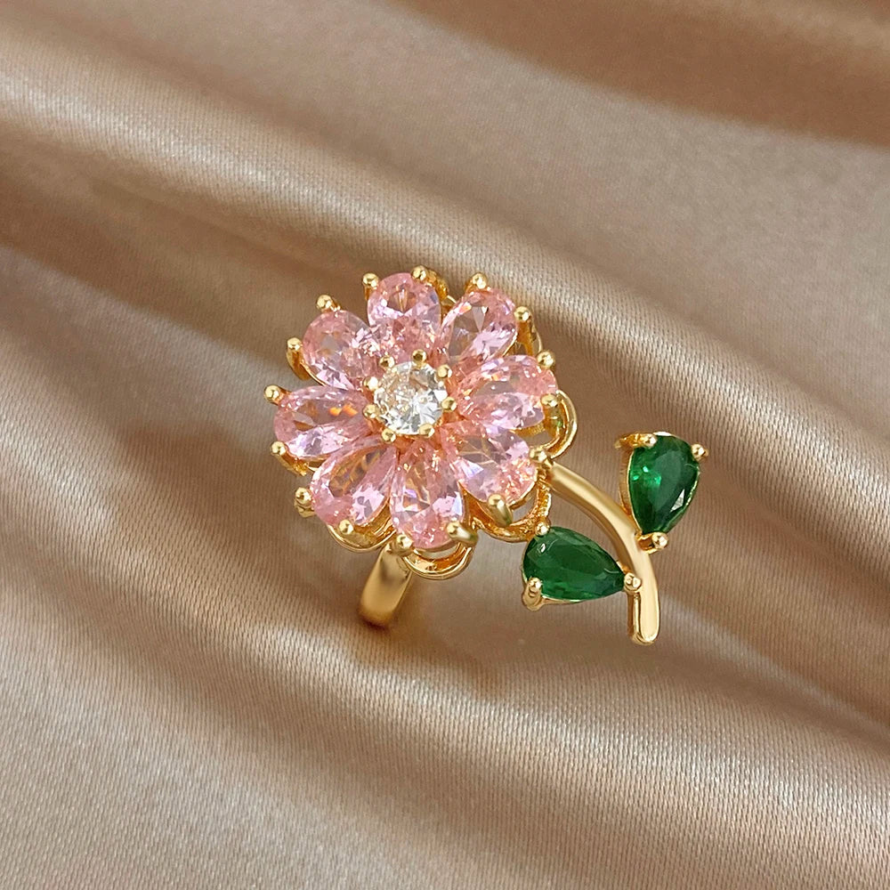 Gold-plated copper flower zirconia ring with pink petals and green leaf accents