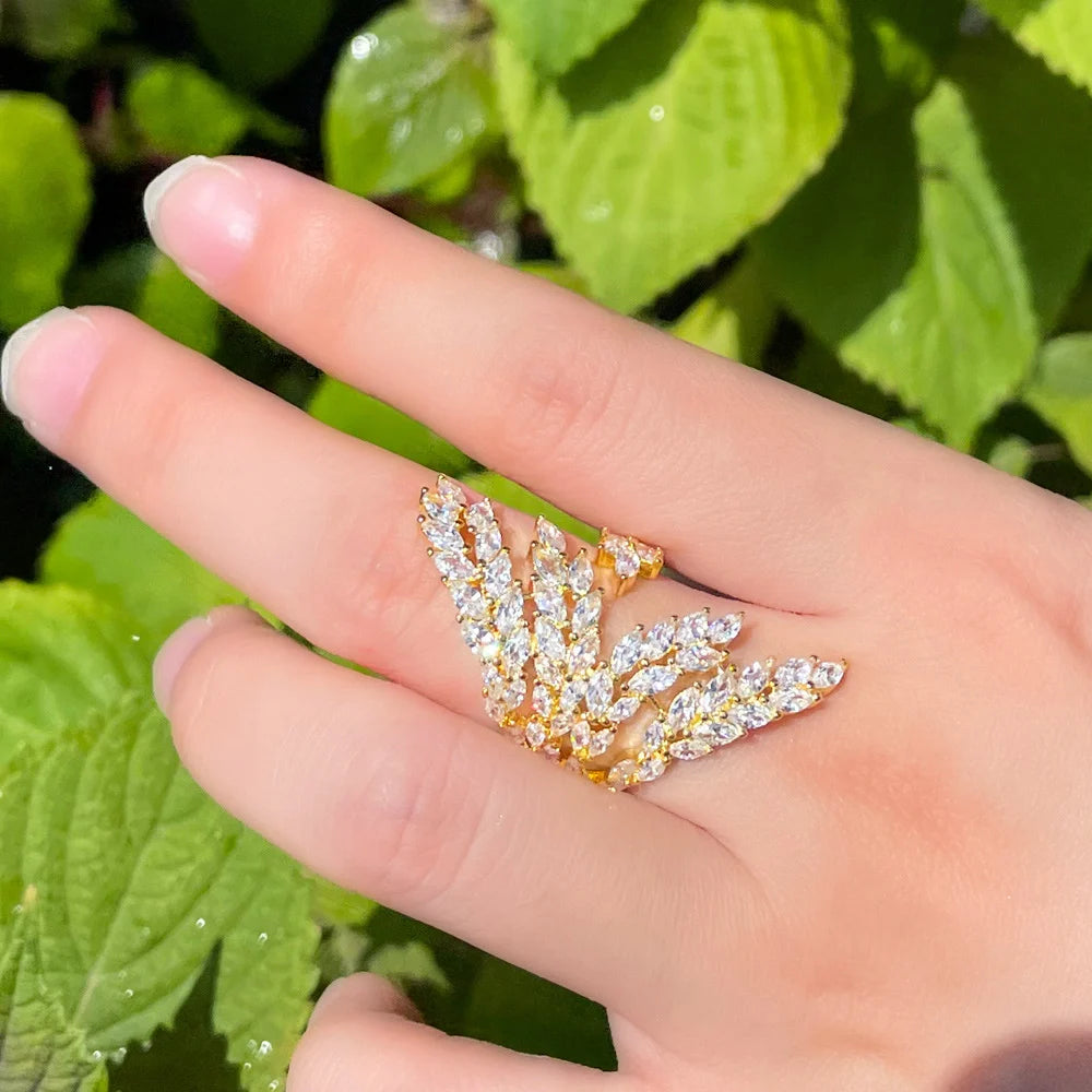 Gold-tone adjustable ring with a branching leaf design and clear stones