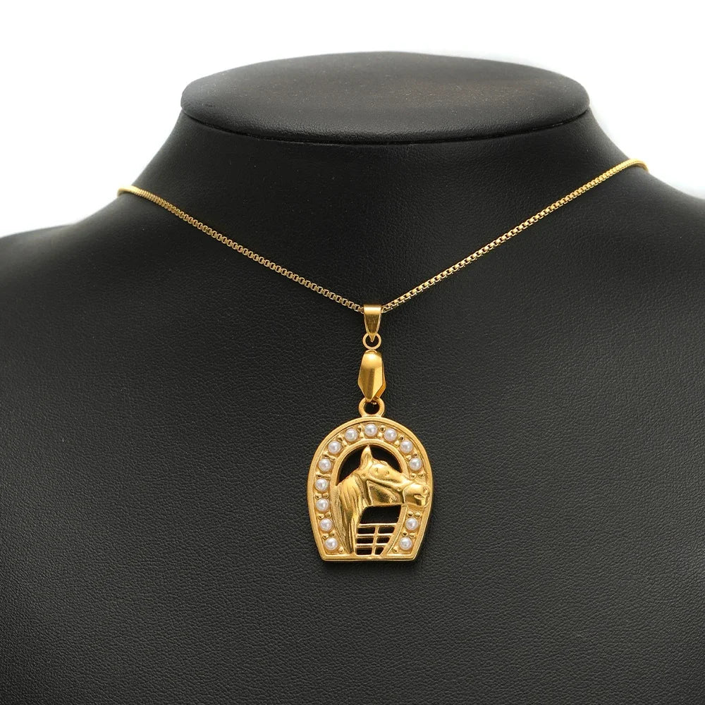 Gold pendant necklace with arch charm, hanging from a loop bail connector