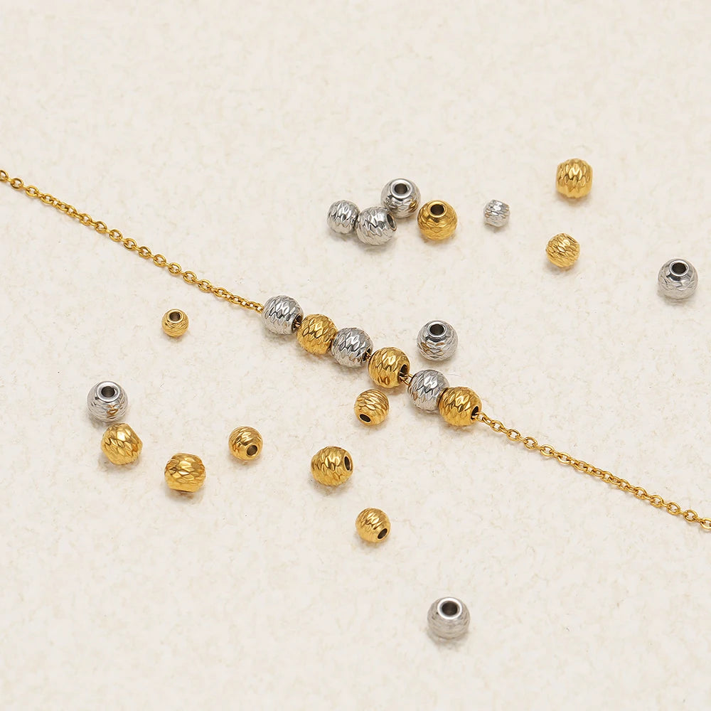 Striped cut flower beads with central holes arranged with a gold chain on display