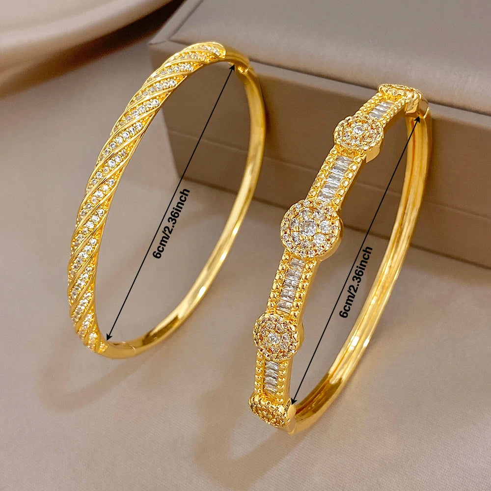 Gold-tone twisted crystal inlay bangles, front view with oval top details