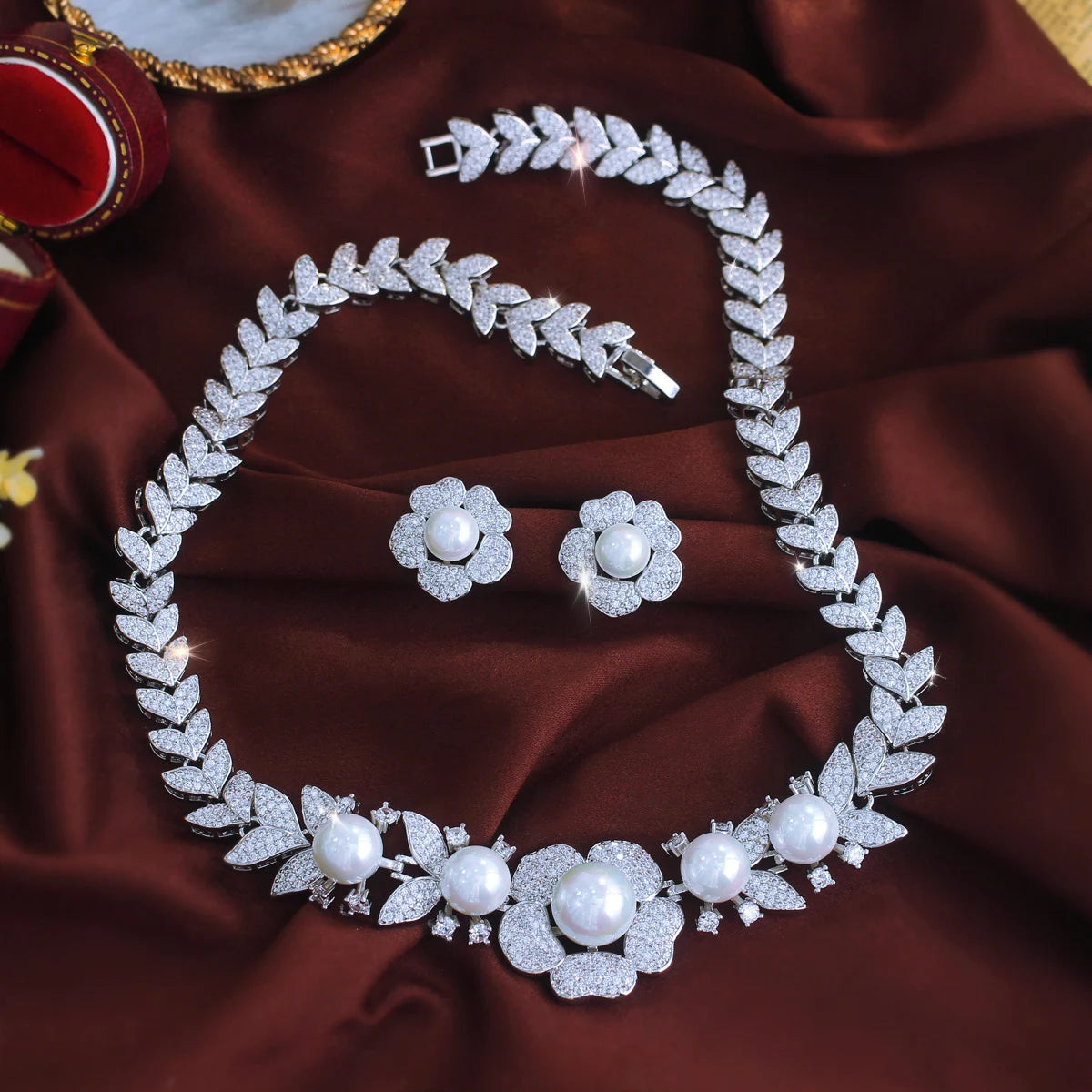 Full jewelry set with leaf-link necklace, flower earrings, and matching bracelet