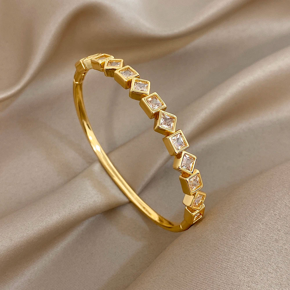 Gold-tone geometric zircon cuff bracelet with square clear stones and open cuff shape