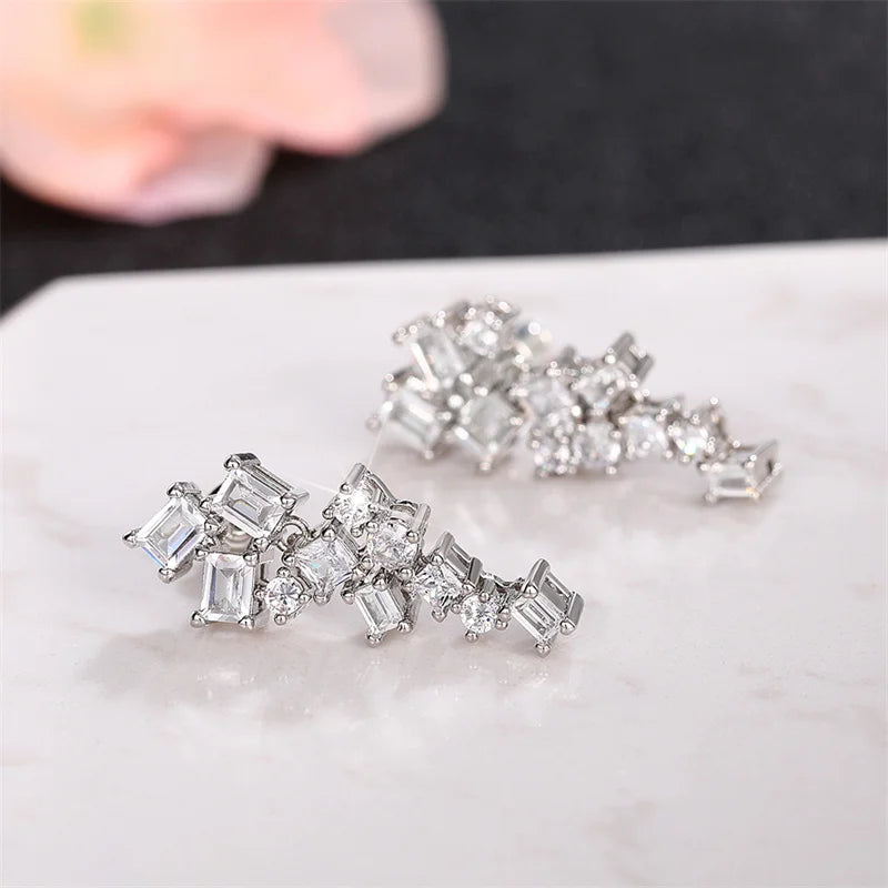 Cubic zircon dangle earrings featuring mixed square and round sparkle stones