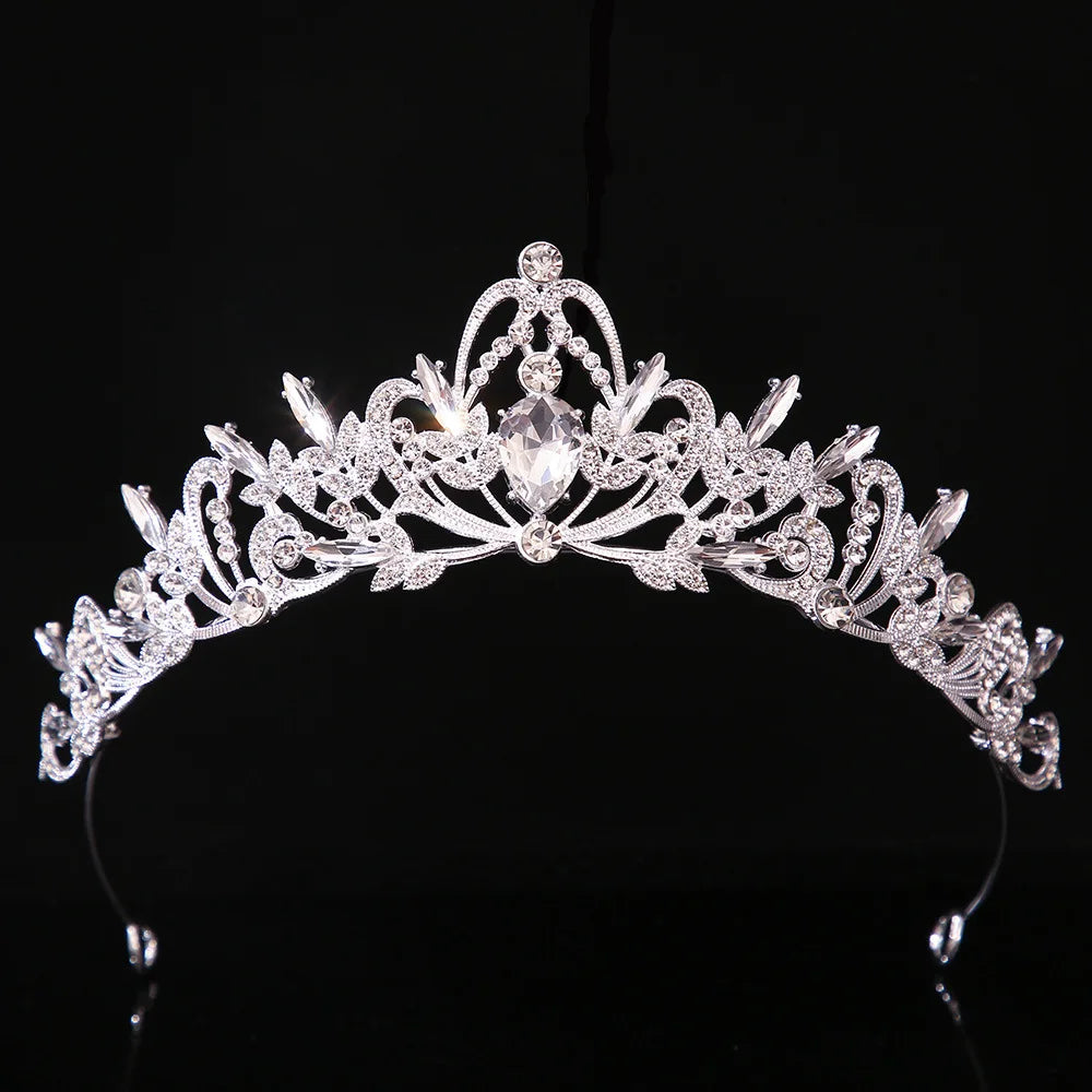 Jeweled bridal tiara crown with clear oval crystals and silver-toned floral filigree