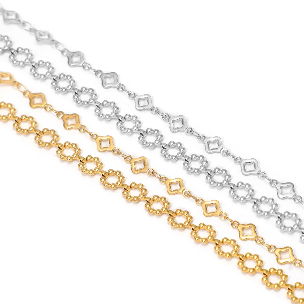 Gold, silver, and steel-toned square-link chains, close-up of connected links