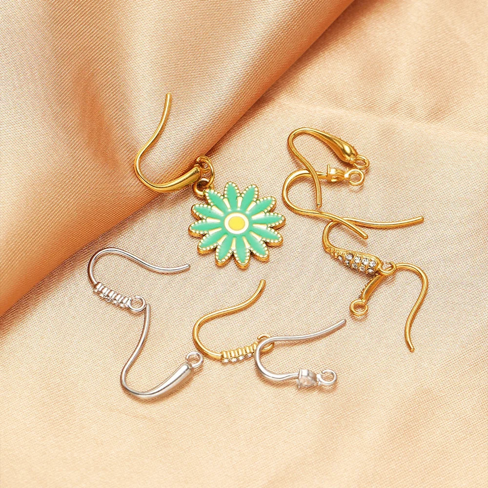 Assorted ear wire hooks in gold and silver tones with crystal and flower charms