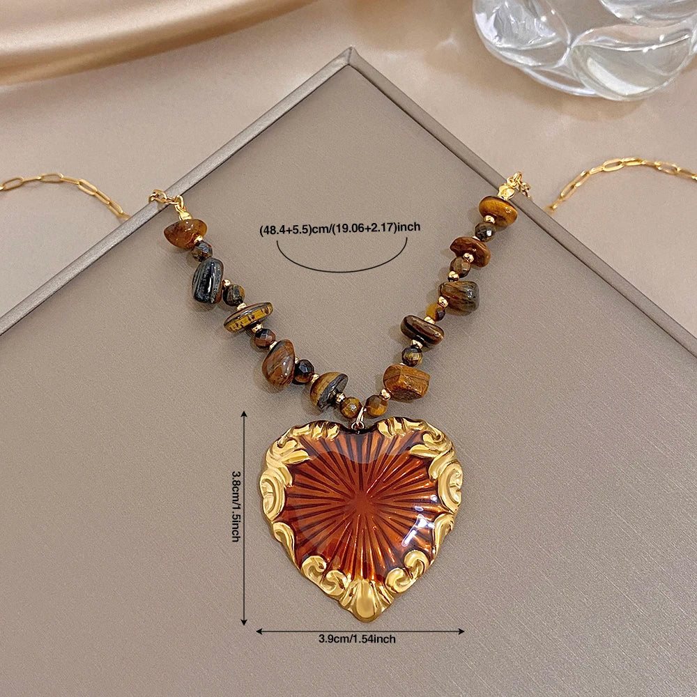 Heart pendant necklace with size reference, gold chain, bead strand, red sunburst charm