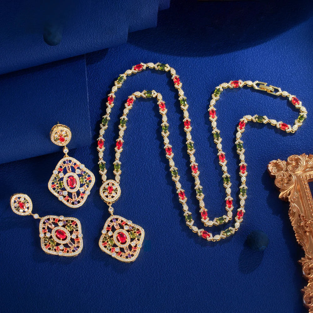 Gold-tone geometric necklace with red and green crystal links and matching earrings