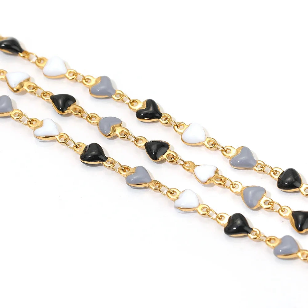 Gold-tone stainless heart link chain with black, white enamel heart charms