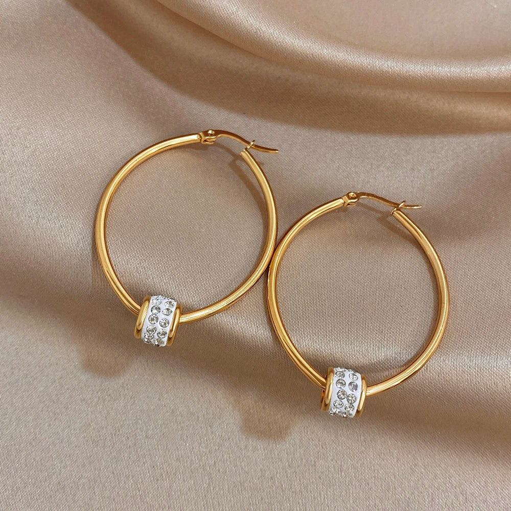 Gold-plated hoop earrings with clear rhinestone bead accents, open round design