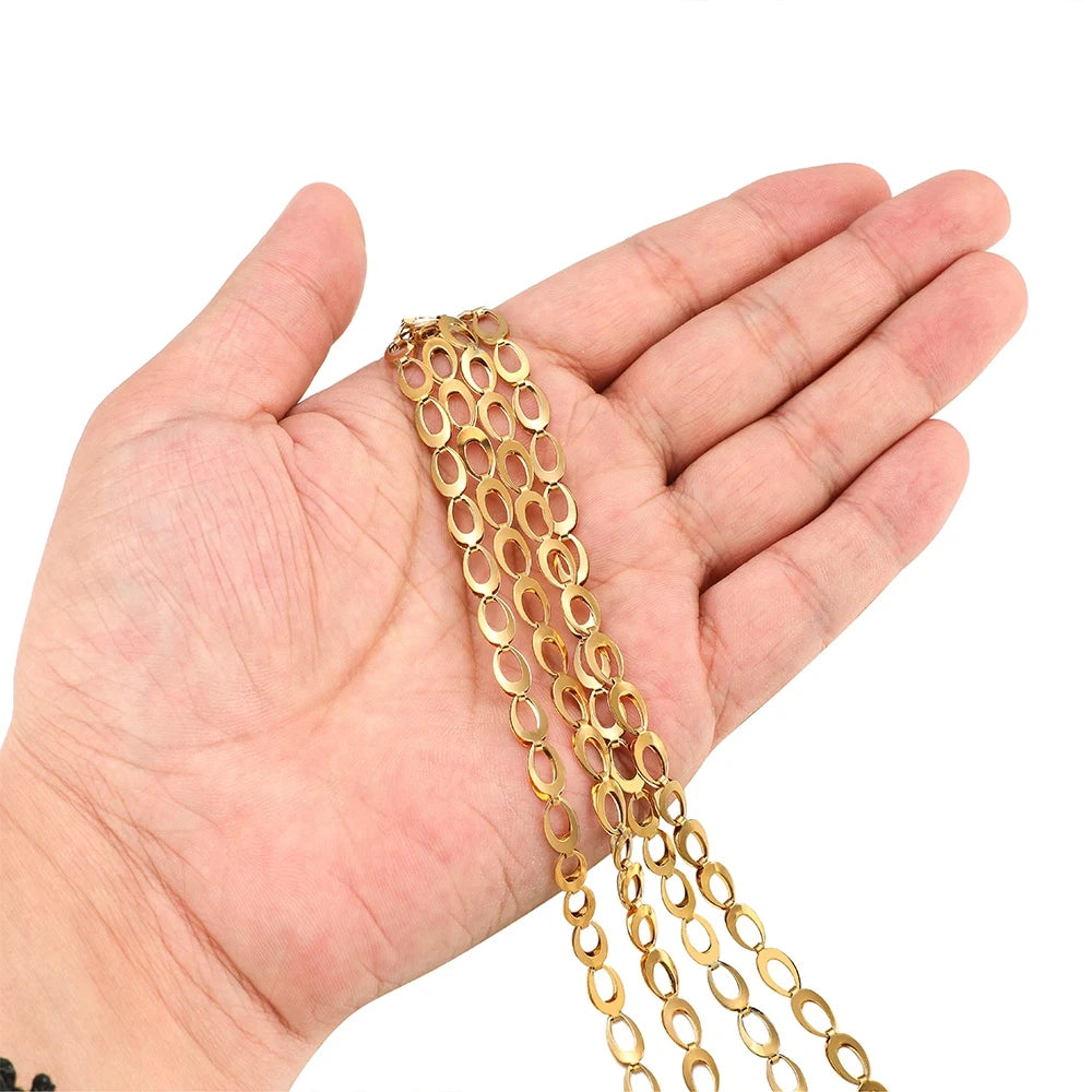 Gold hollow teardrop chain bracelet with oval links shown on open palm