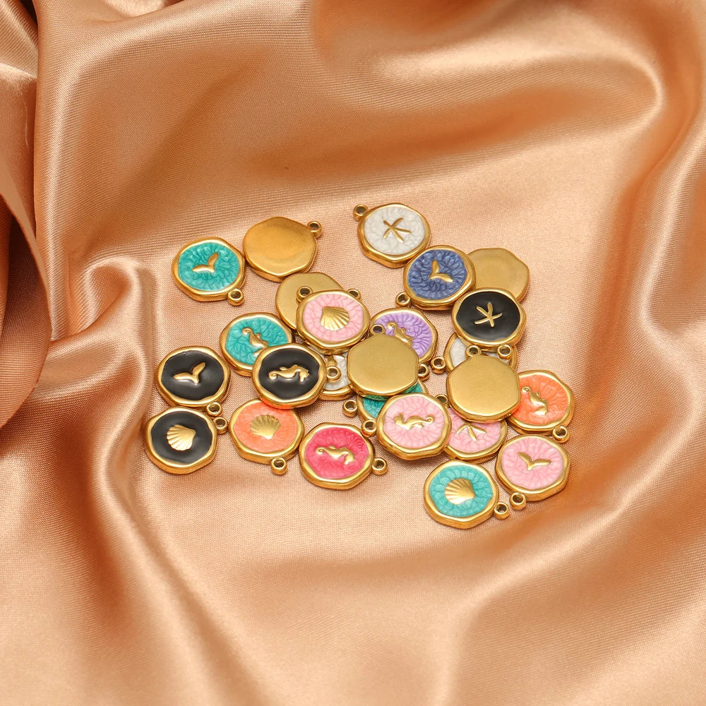 Assorted enamel animal charm pendants in gold-tone frames with colorful motifs