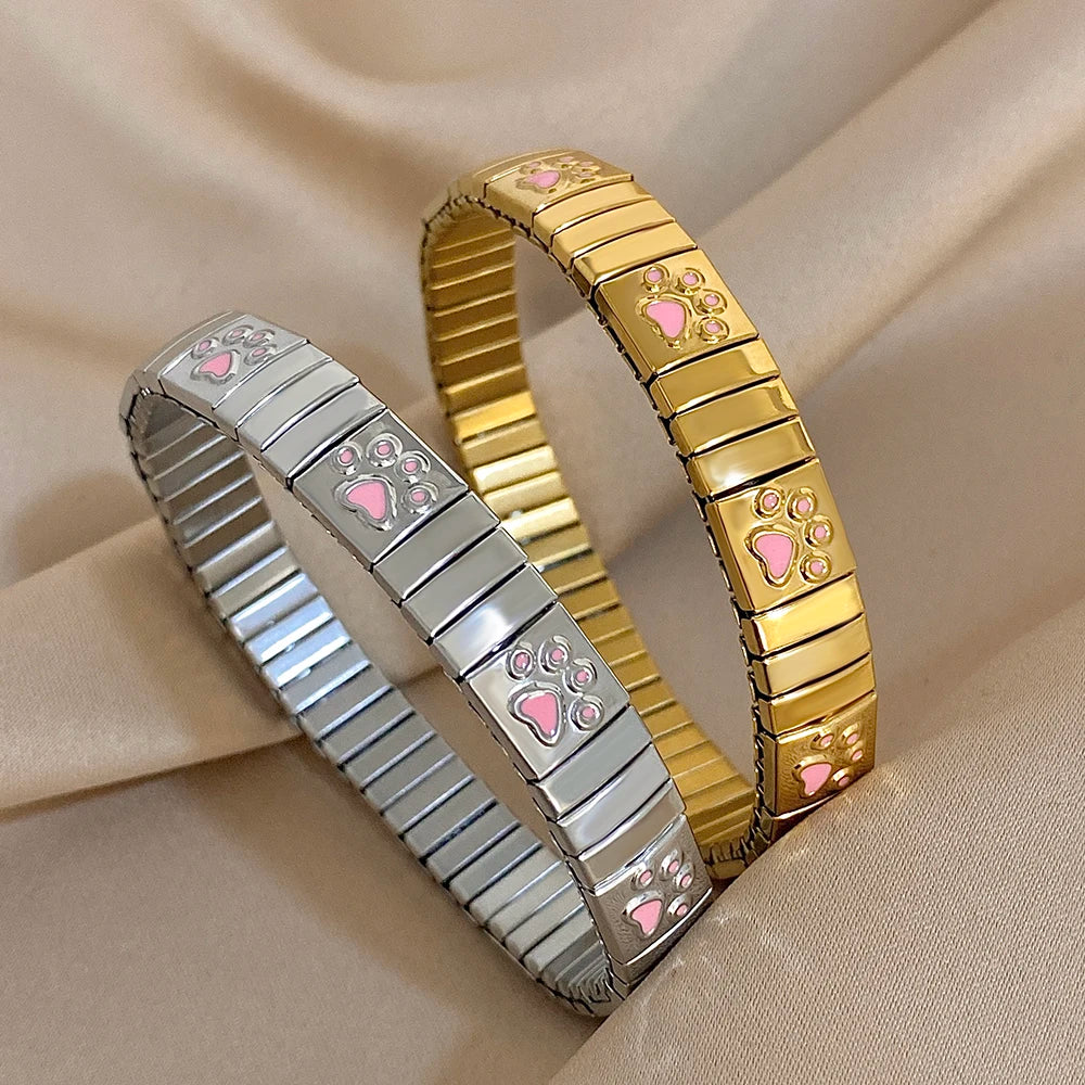 Stainless steel bracelets set with gold and silver enamel paw print links, elastic bangle.