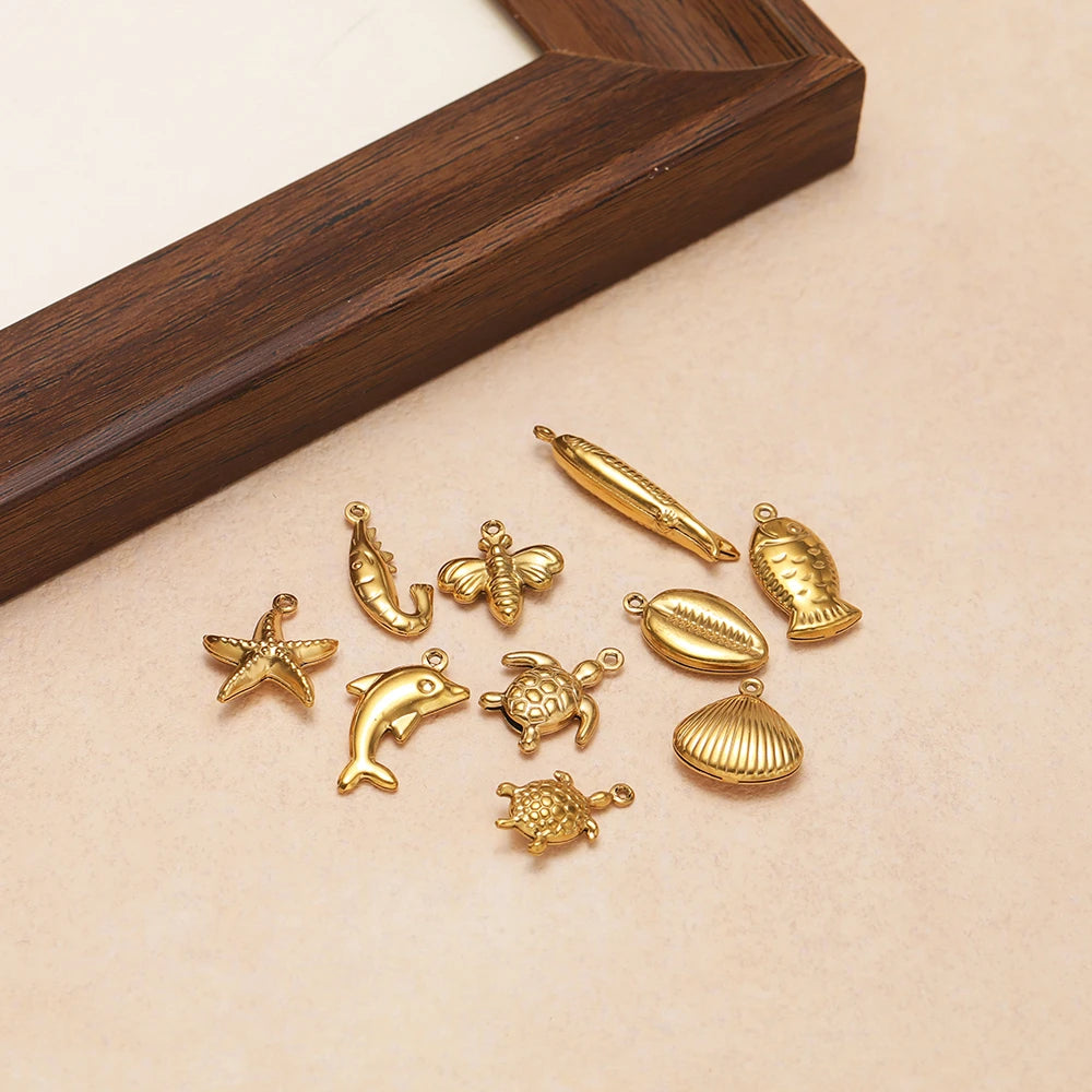 Gold-toned ocean animal hollow charms assortment with fish, dolphin, starfish, sea turtle