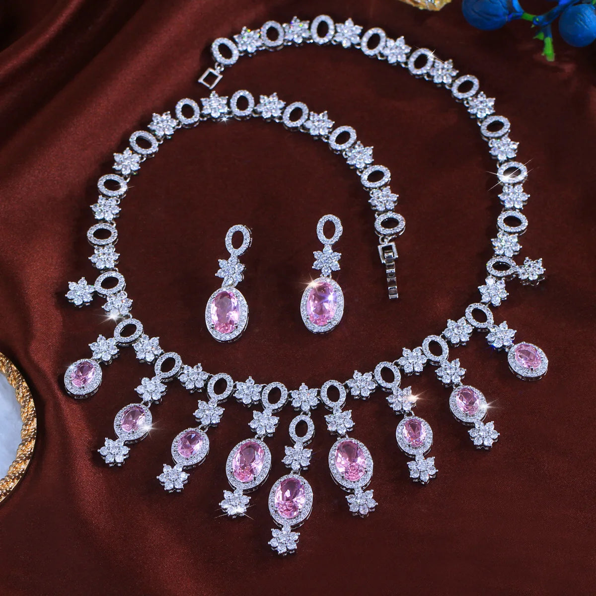 Full necklace and matching drop earrings with pink oval stones and clear floral crystals