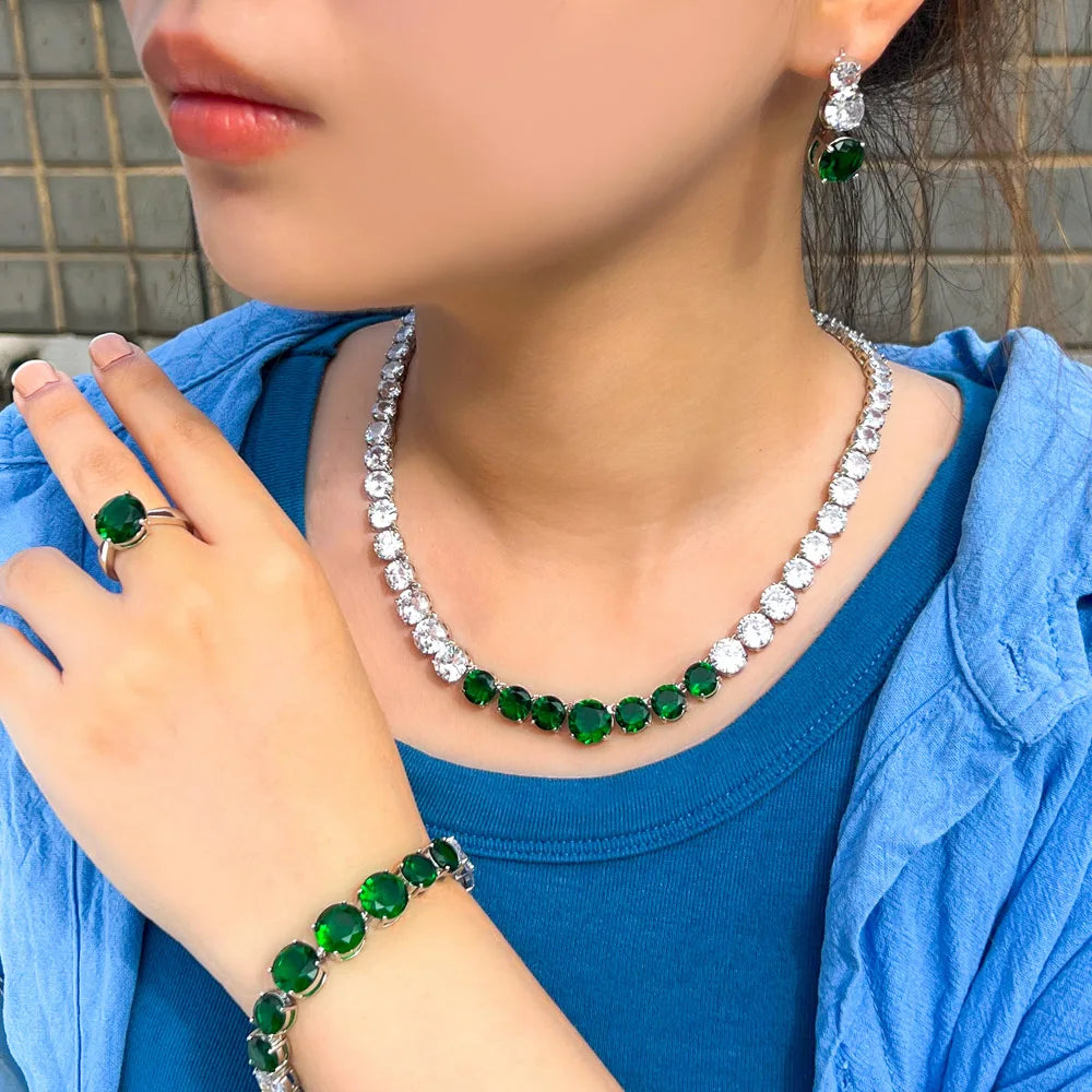 Green cubic zirconia tennis jewelry set: necklace, bracelet, ring, and matching earrings