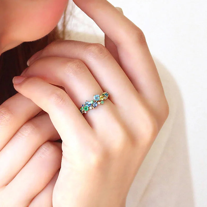 Gold-tone multicolor cubic zirconia band ring with blue and green stones, close-up