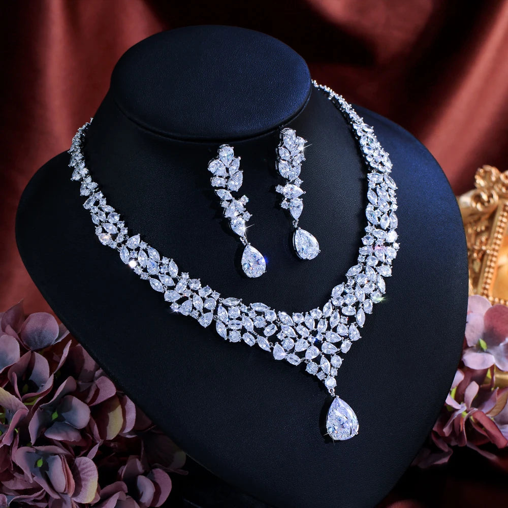 CZ necklace and drop earrings displayed together, with a floral V-shaped necklace