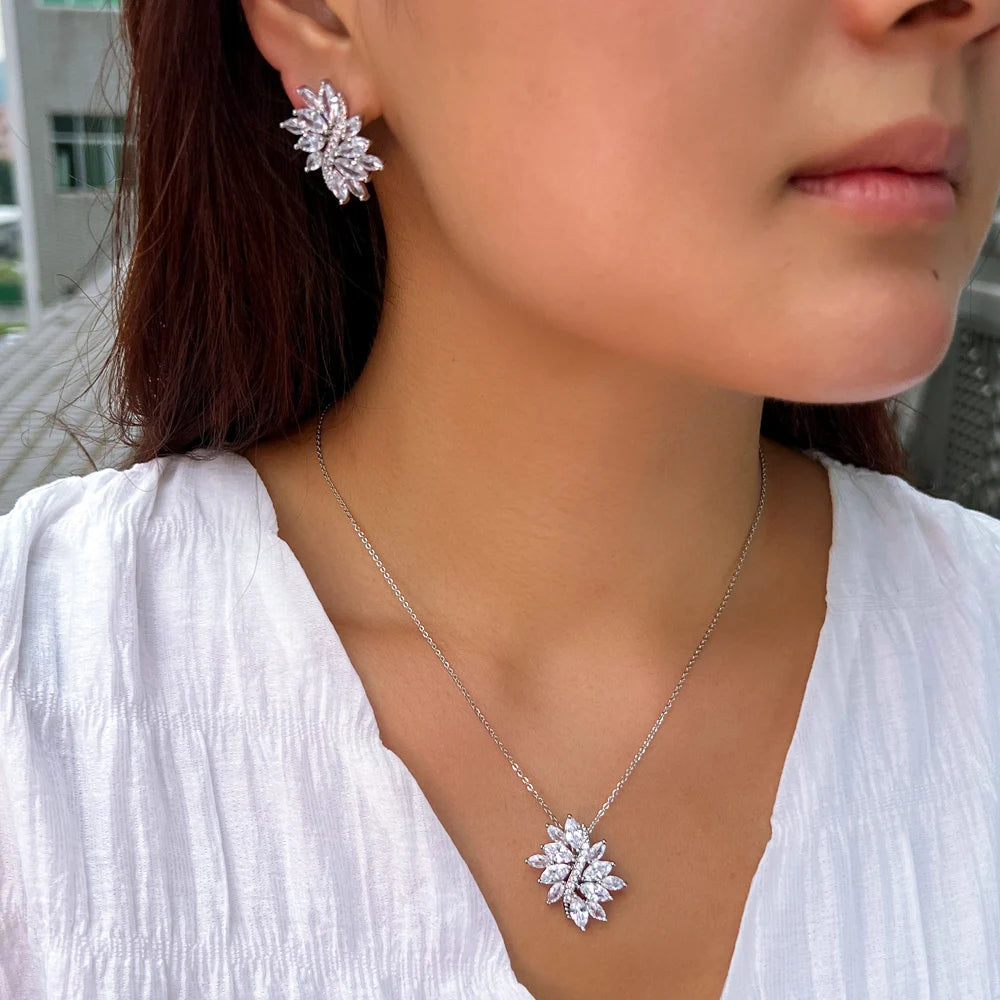 Silver-tone zirconia leaf necklace and matching earring modeled on a person