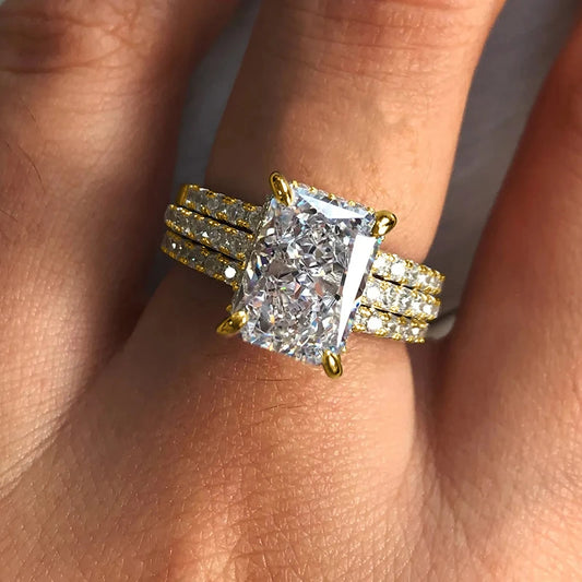 Gold tone geometric cubic zirconia ring set with square center stone and side bands