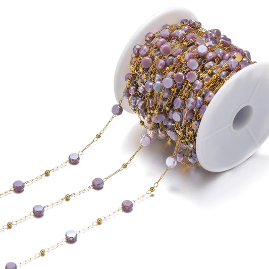 Purple crystal bead chain with gold links on a white spool for DIY jewelry making