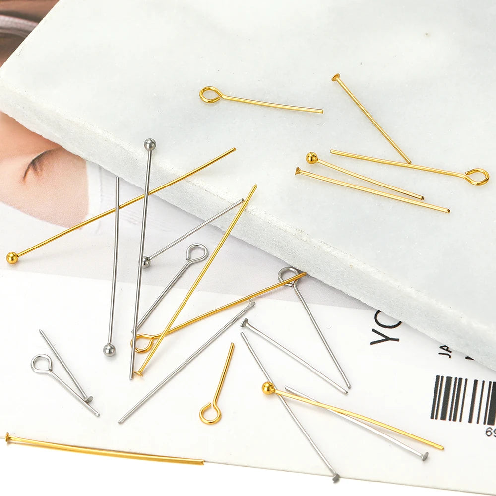 Mixed gold and silver T-eye pins with ball heads on a packaged backing card