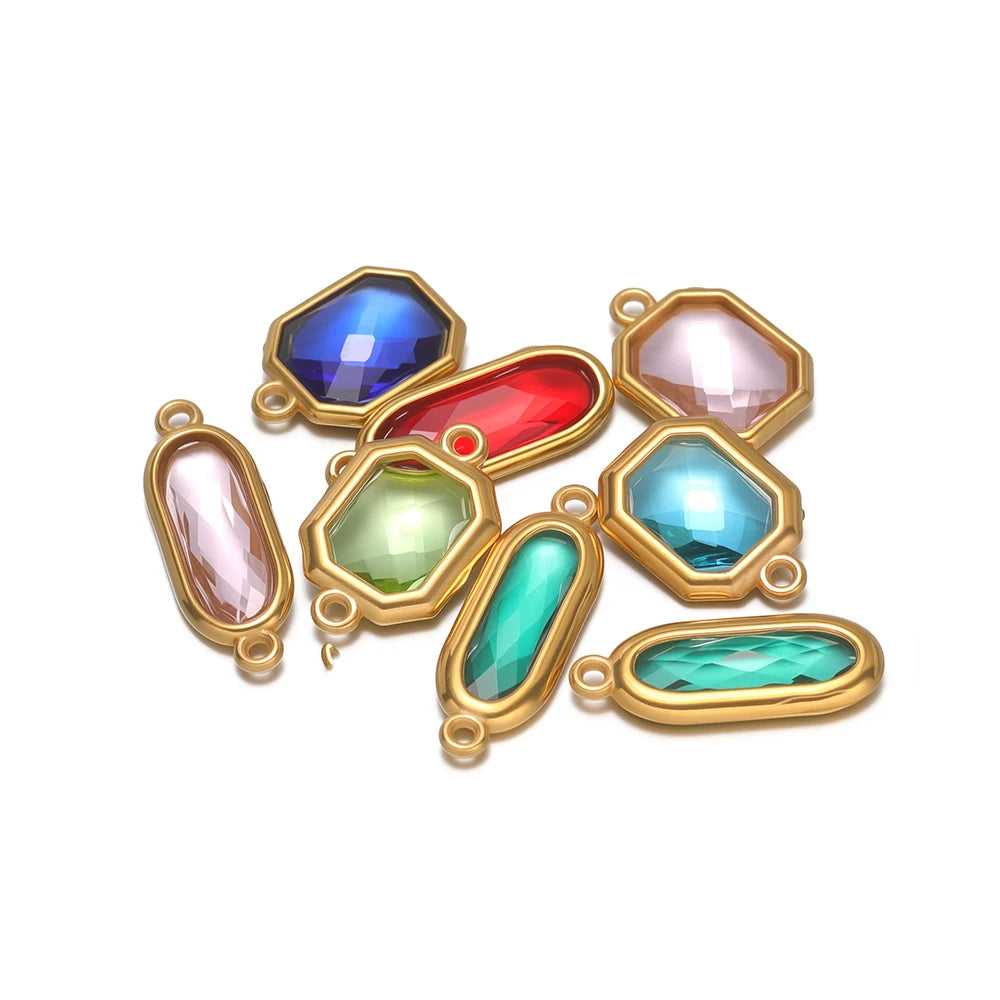 Assorted faceted glass charm connectors in blue, red, pink, and green with gold-tone loops