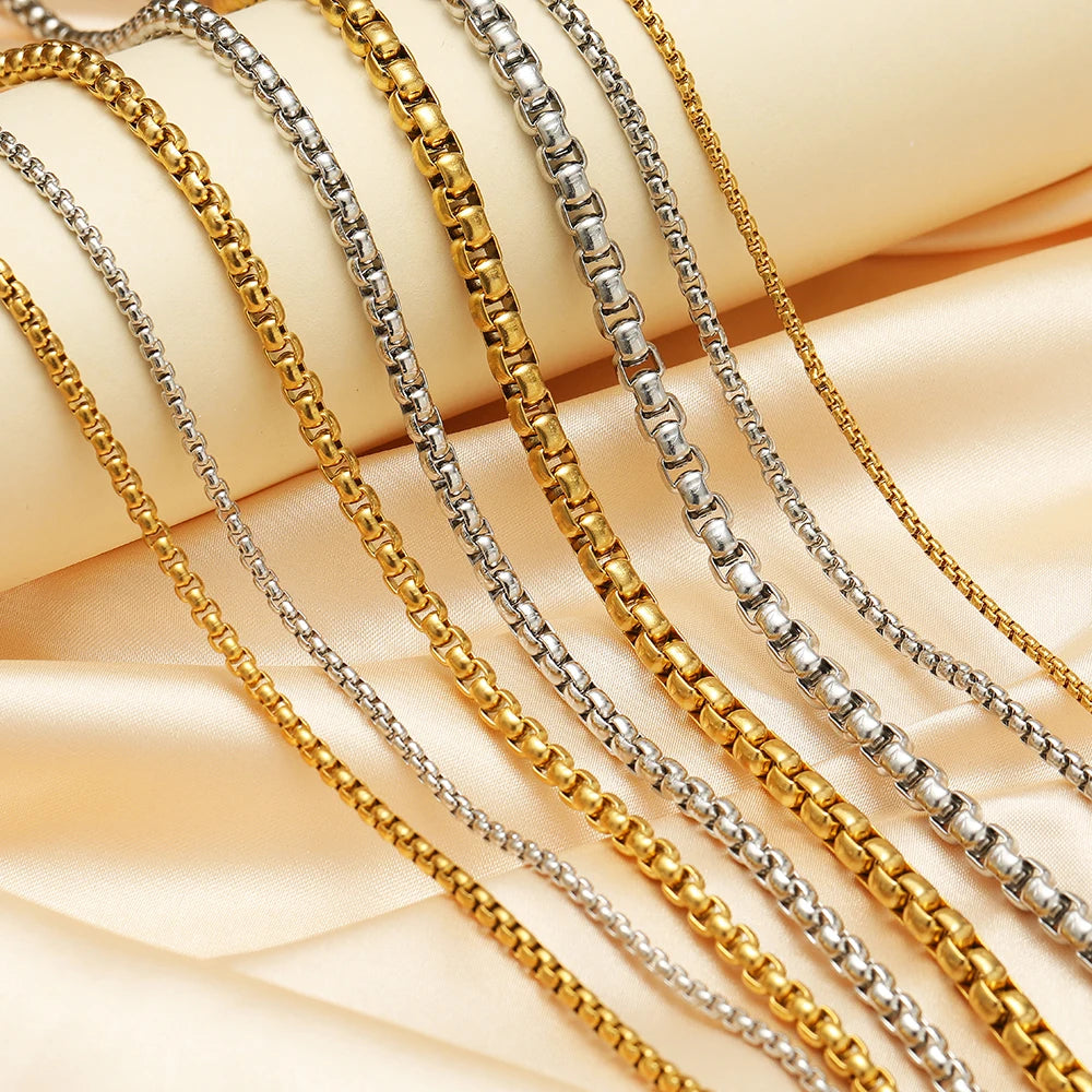 Assorted rolo box chains: gold and silver linked strands laid out