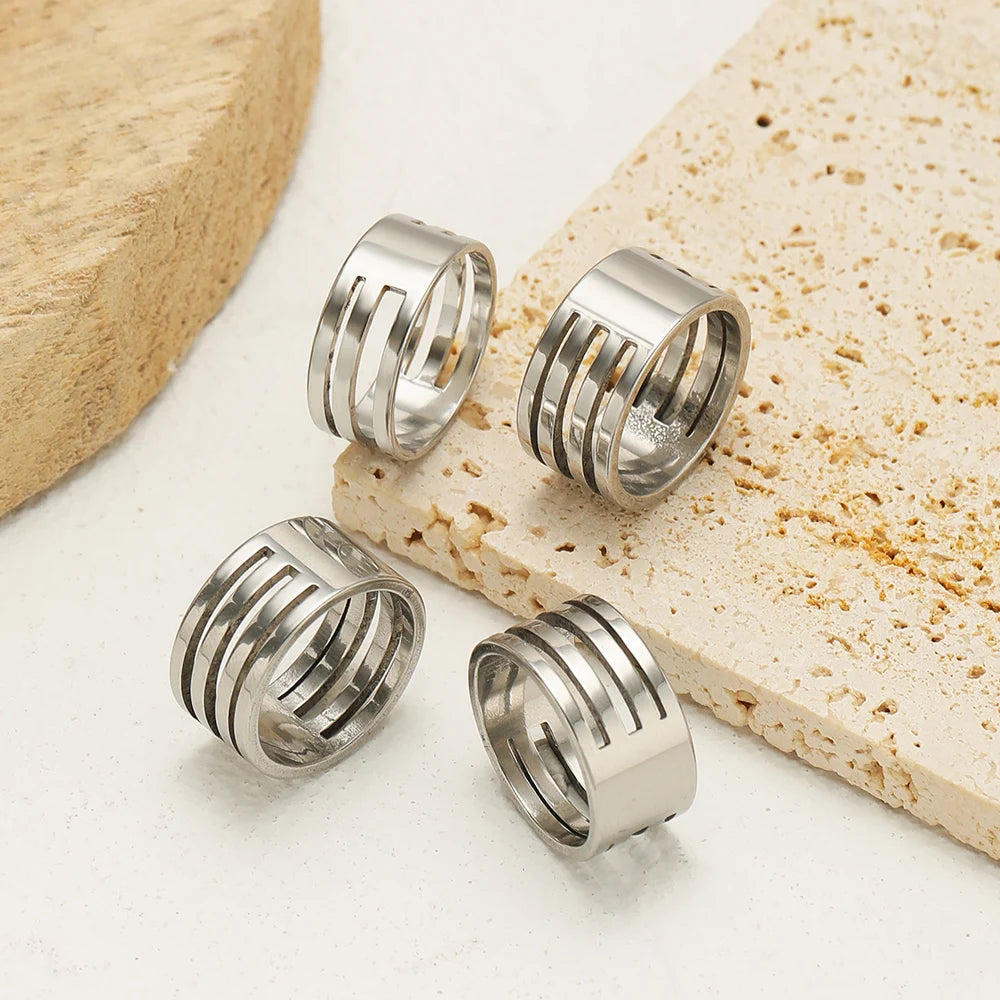 Five stainless steel ridged jump ring opener finger rings on display